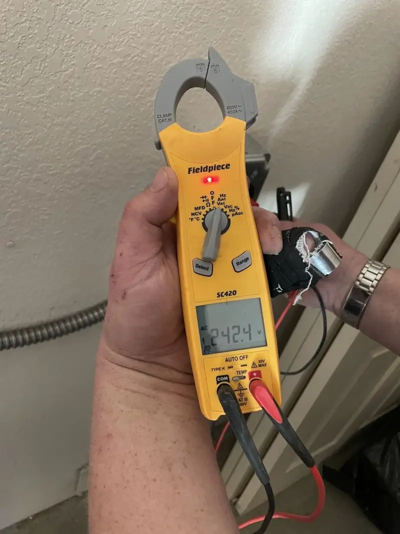 Voltage testing with clamp meter during Recessed Lighting Installation in Town and Country